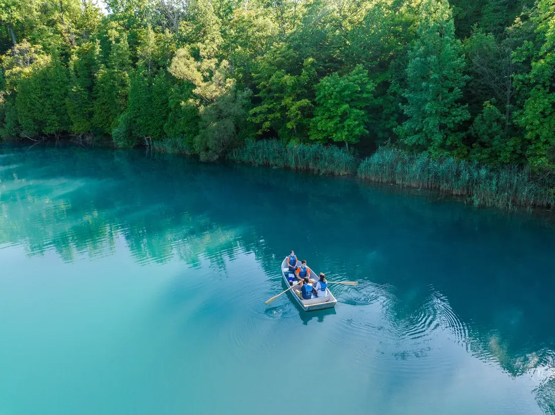 People on boat in Green Lakes park.